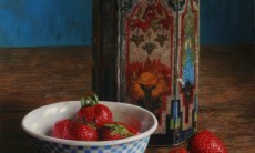 Bowl of strawberries with old tin